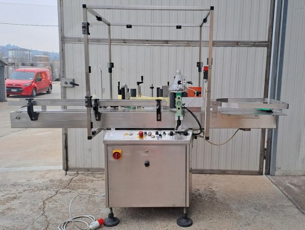 ADHESIVE LABELLING MACHINE ENOS MOD. “BASE” FOR ROUND AND SQUARE BOTTLE UP TO  5 LT WITH TWO STATION, SECOND-HAND MACHINE